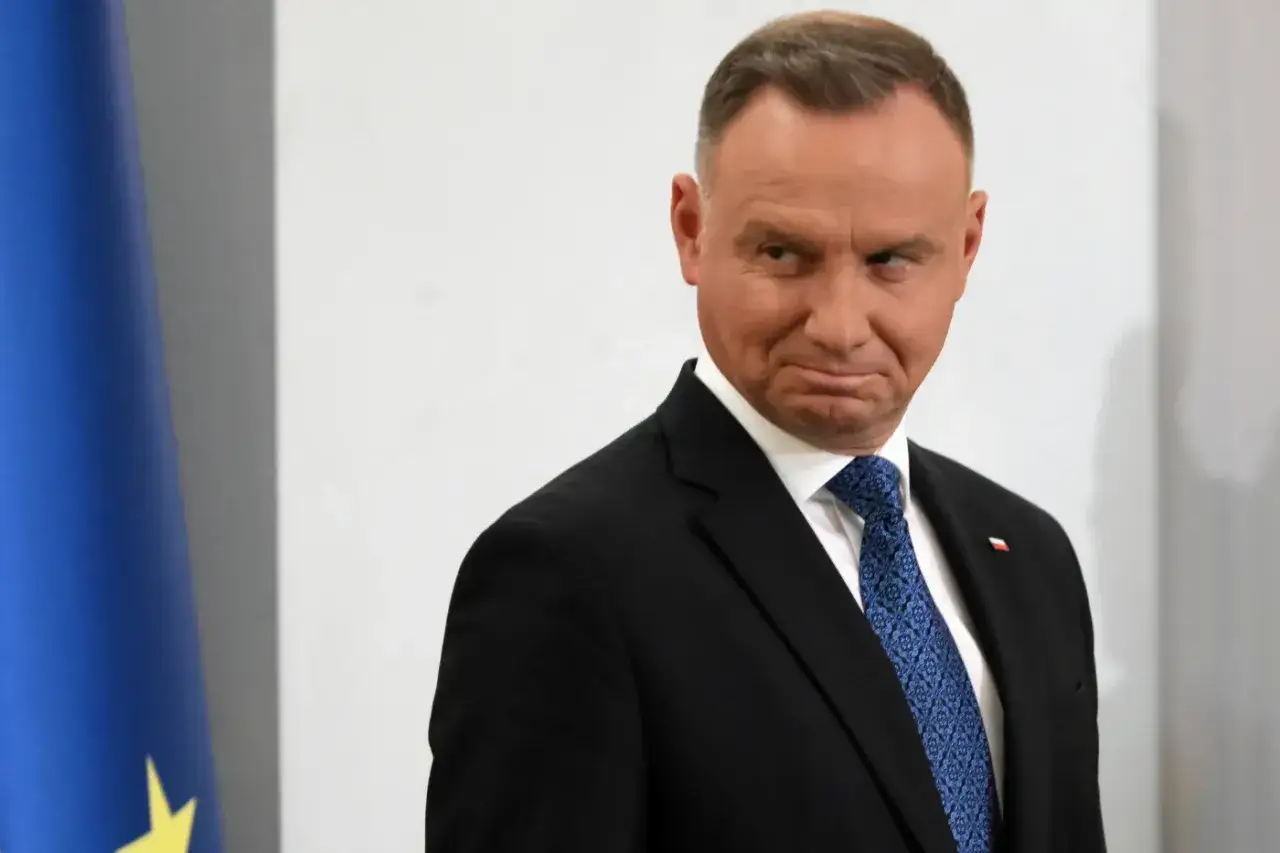 Prezydent Andrzej Duda w garniturze i krawacie, obok flagi UE. Zastanawia się, co to jest kadencja.