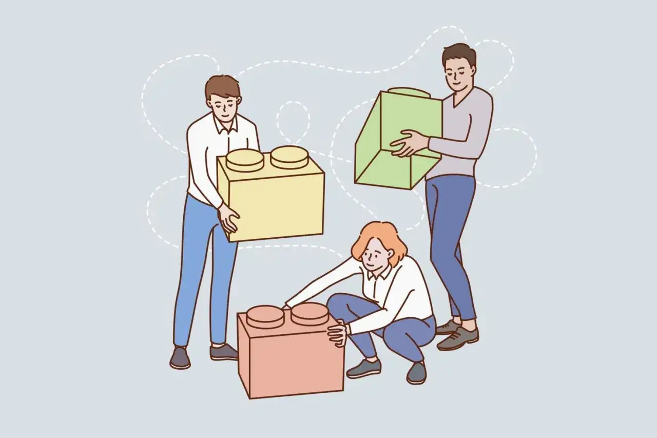 Tres personas construyen algo juntas, creando una conexi&oacute;n emocional.