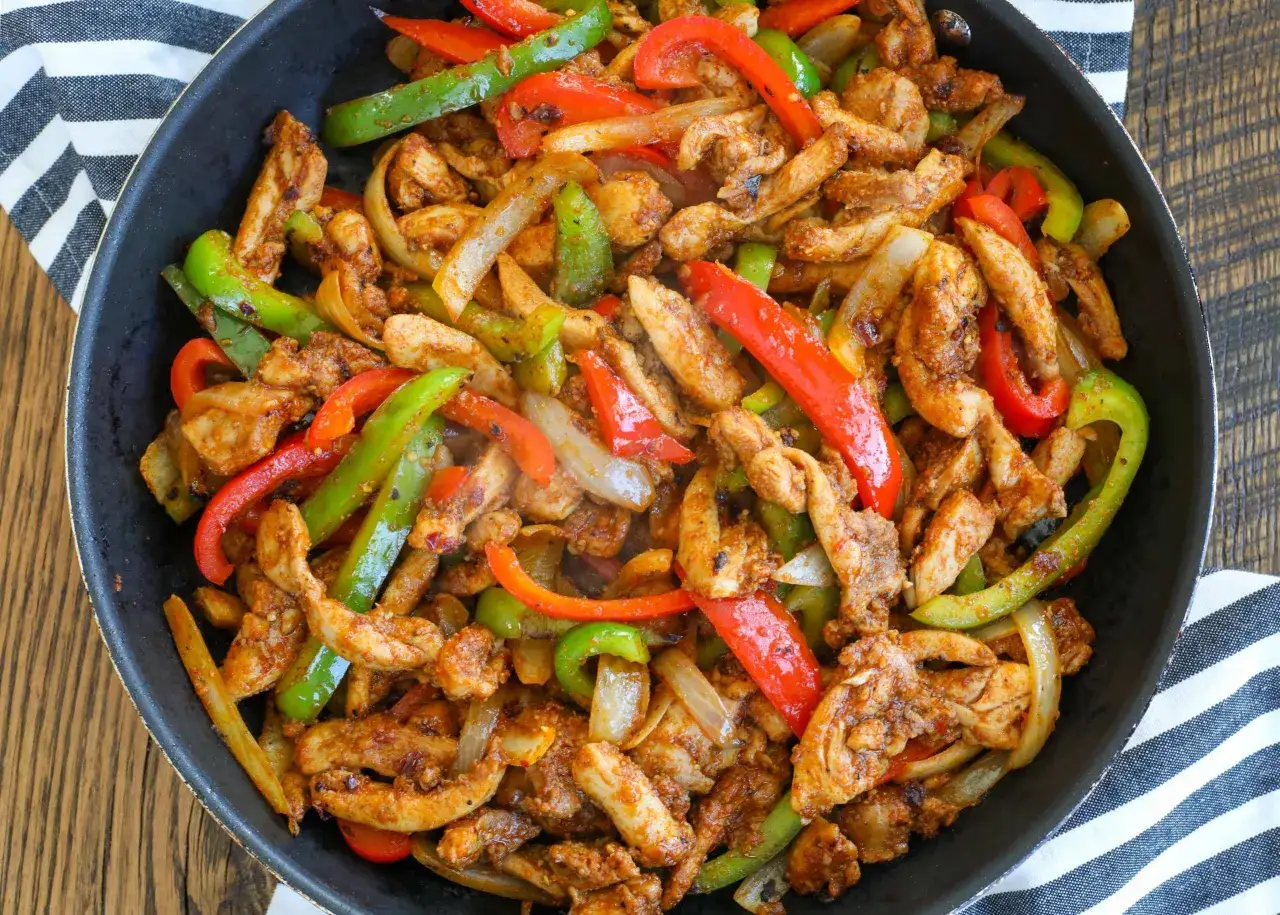Würziges Hähnchen mit Paprika und Zwiebeln in der Pfanne, perfekt für ein schnelles Fajitas Rezept.