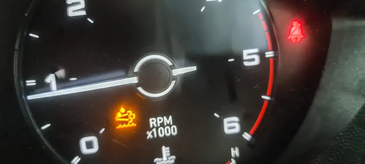 Varning för lågt spolarvätskenivå på instrumentpanelen i en Fiat Ducato. En röd symbol för säkerhetsbälte lyser också.