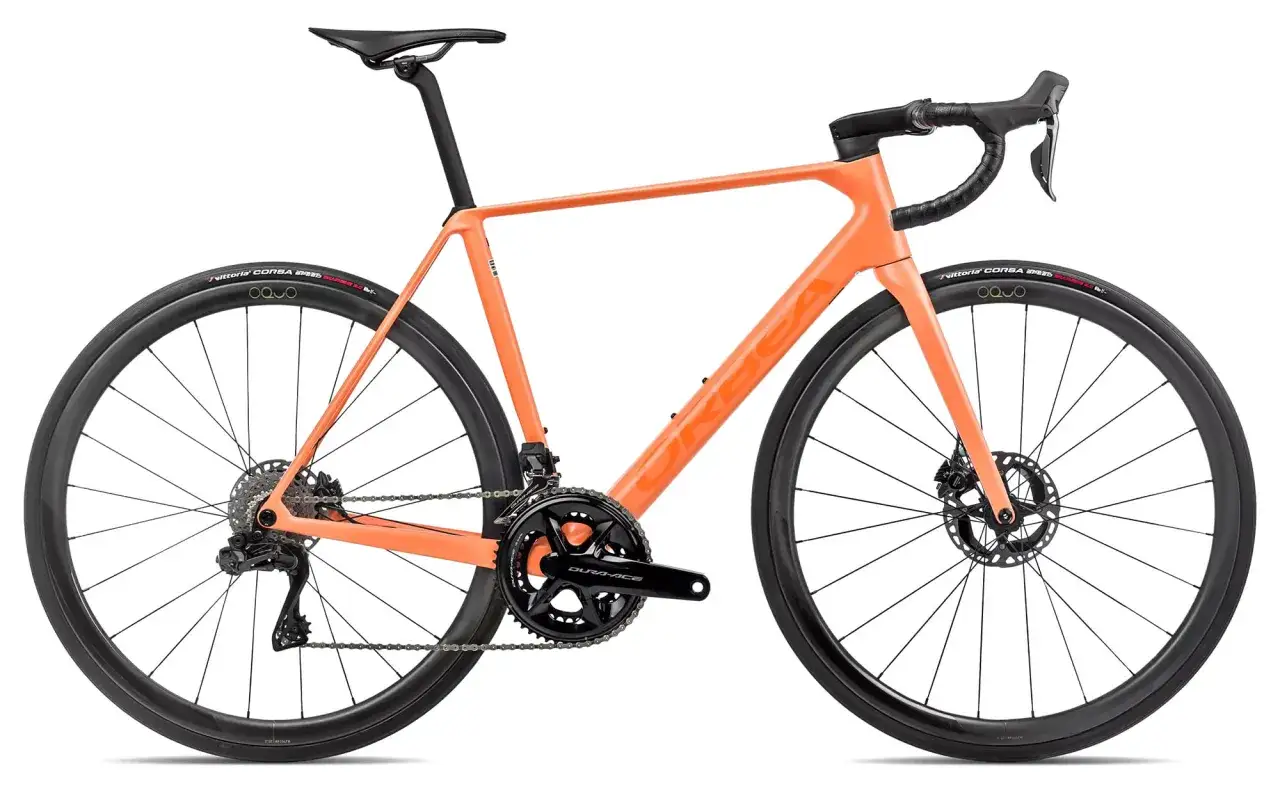 An orange Orbea Orca road bike, ready for a review. Features disc brakes, Shimano Dura-Ace components, and Vittoria Corsa tires.
