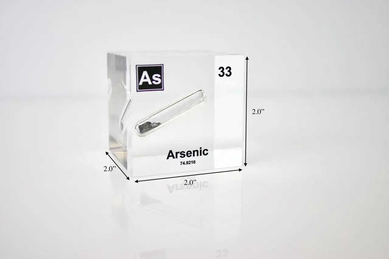 Ein W&uuml;rfel aus Acryl zeigt das chemische Element Arsen (As) mit der Ordnungszahl 33. Das Element ist in einem R&ouml;hrchen eingeschlossen.