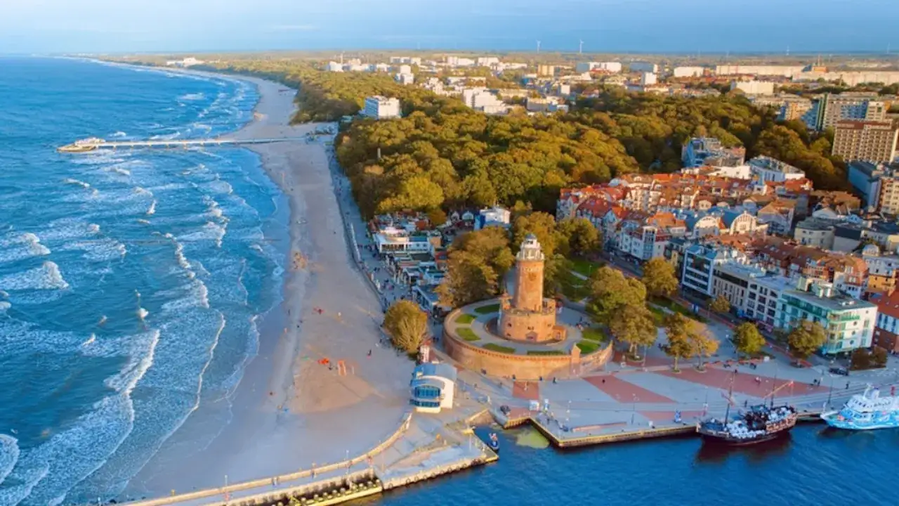 Widok na plażę, morze i latarnię morską. Idealne miejsce, gdzie najlepiej nad morze, z promenadą i portem.