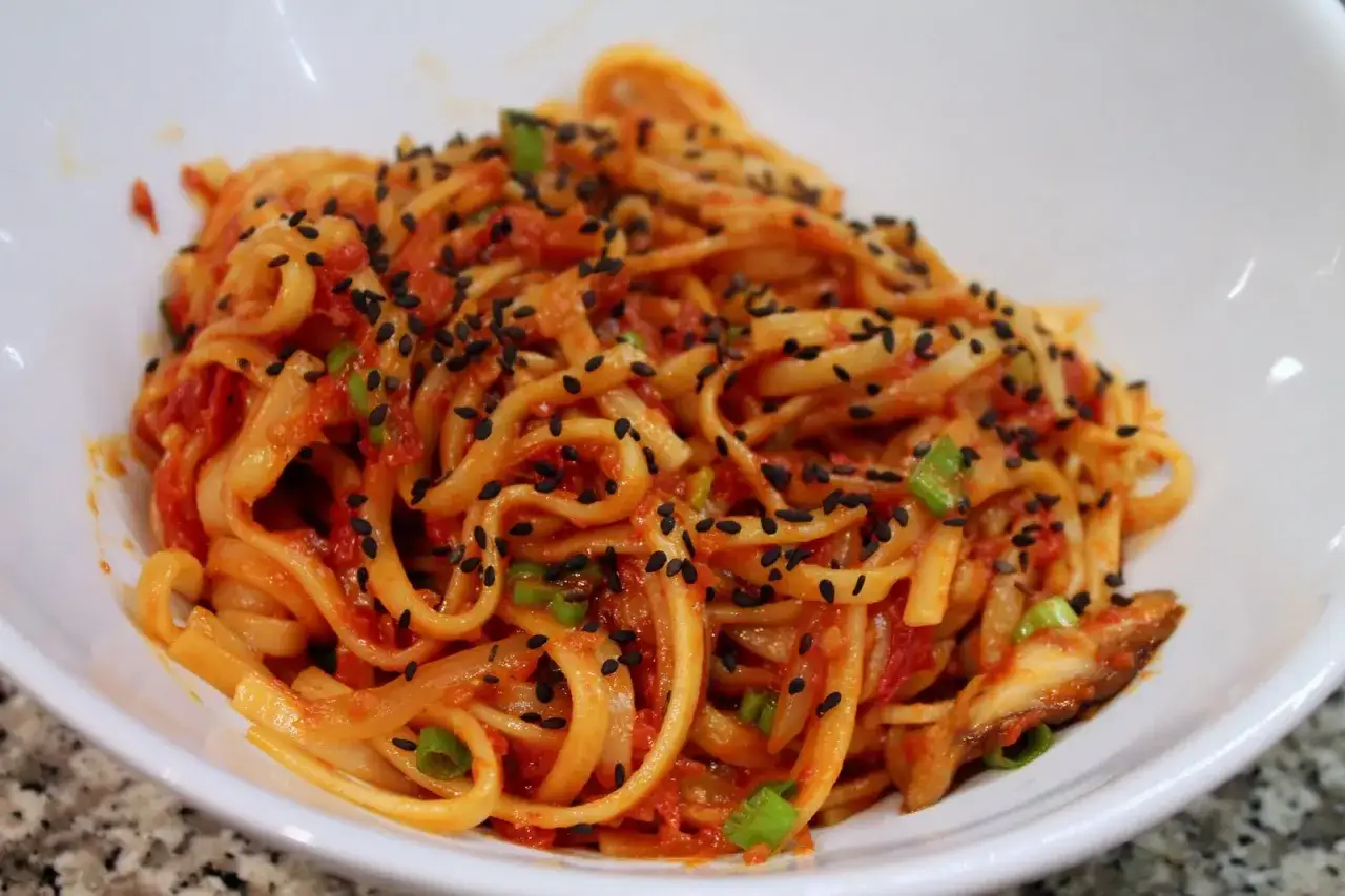 Pyszny makaron udon w sosie pomidorowym z czarnym sezamem i szczypiorkiem. Idealny makaron udon przepis na szybki obiad.