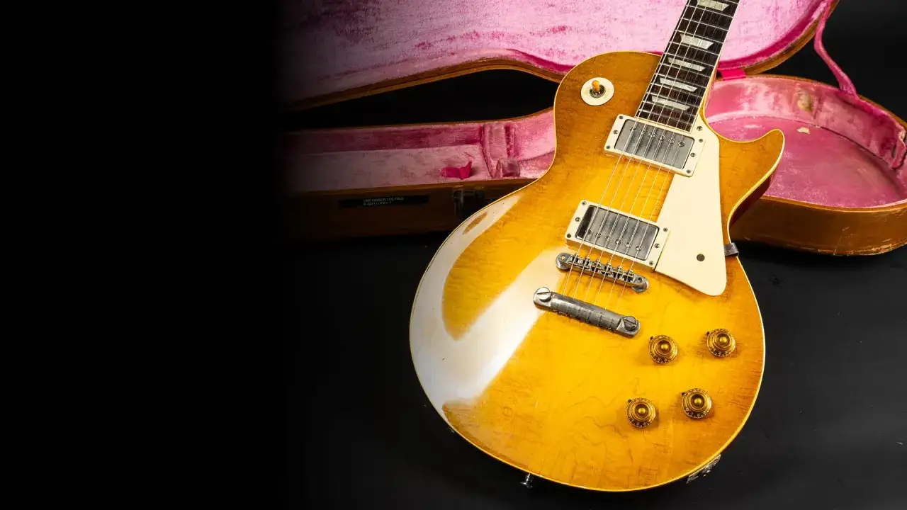 Eine goldene E-Gitarre mit pinkem Koffer. So könnte die erste Gitarre ausgesehen haben, ein Meisterwerk der Musikgeschichte.