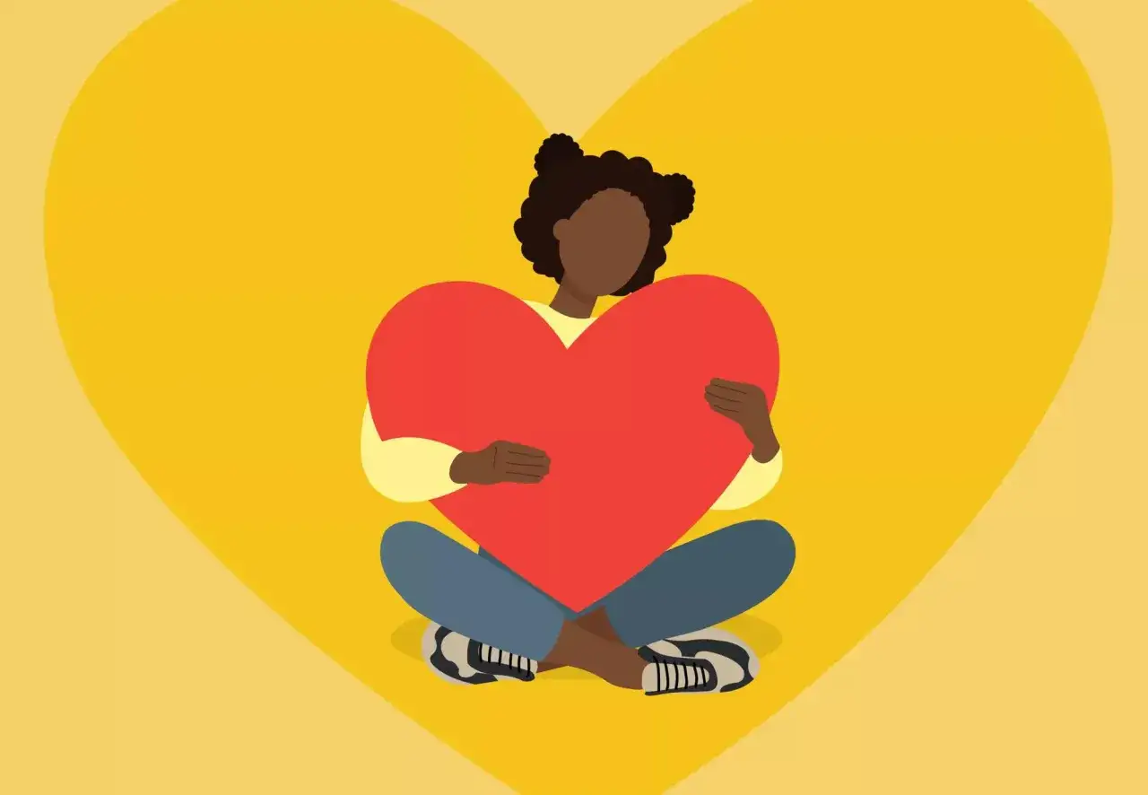 Ragazza con cuore rosso, simbolo di amor proprio e psicologia.