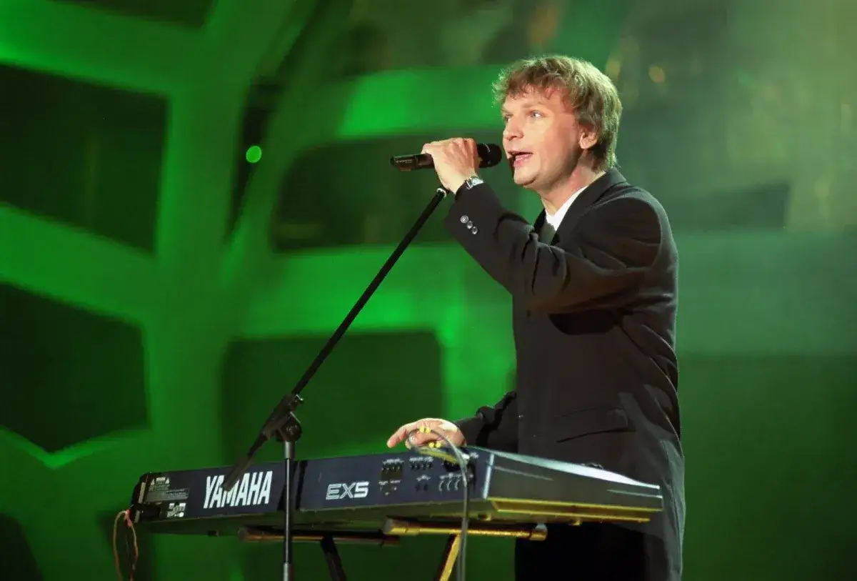 Grzegorz Ciechowski, w czarnym garniturze, śpiewa przy keyboardzie Yamaha EXS. Jego utwory poruszały serca wielu.