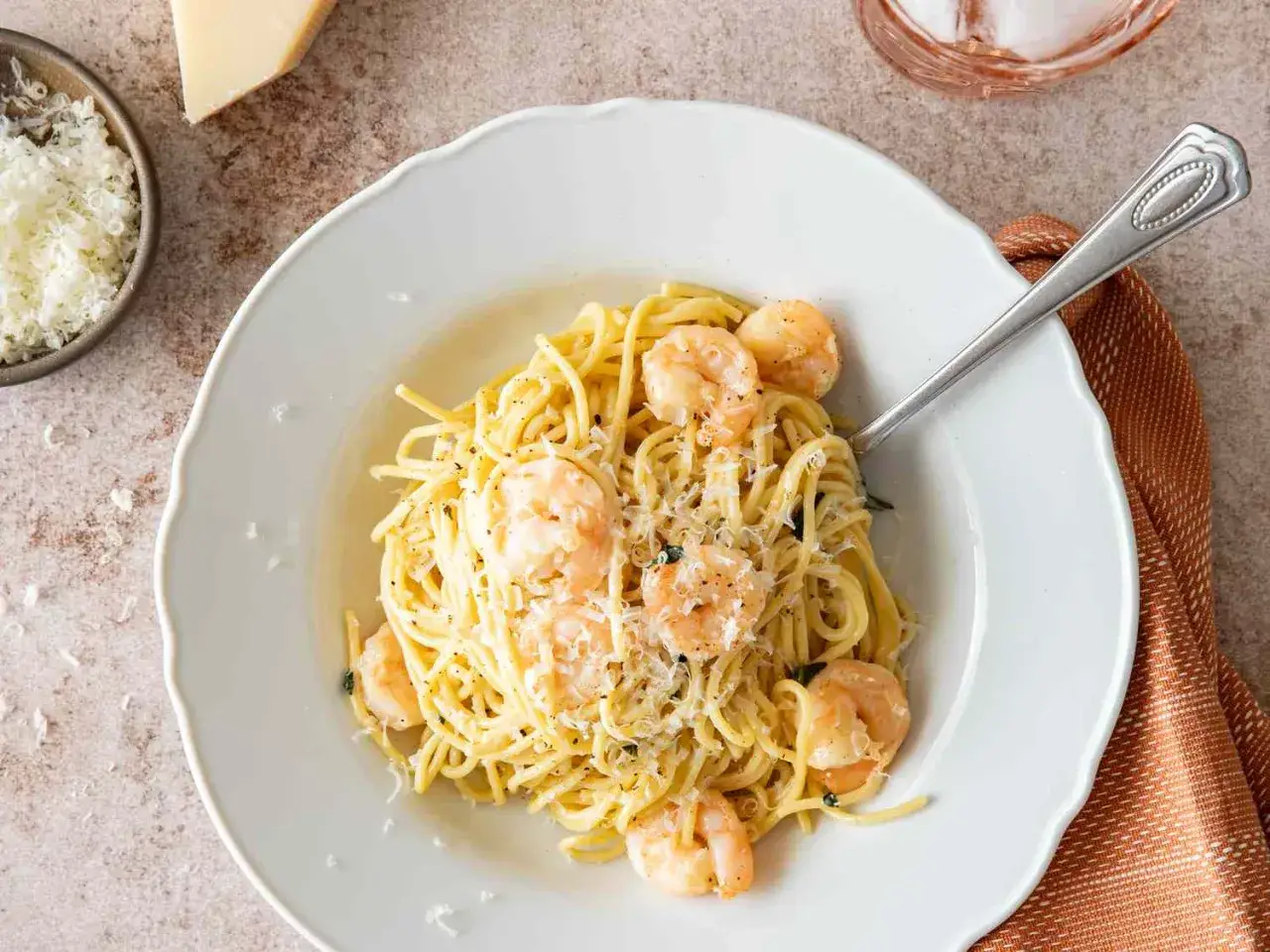 Deliciosa pasta con salsa de langostinos, espolvoreada con queso rallado y pimienta negra.