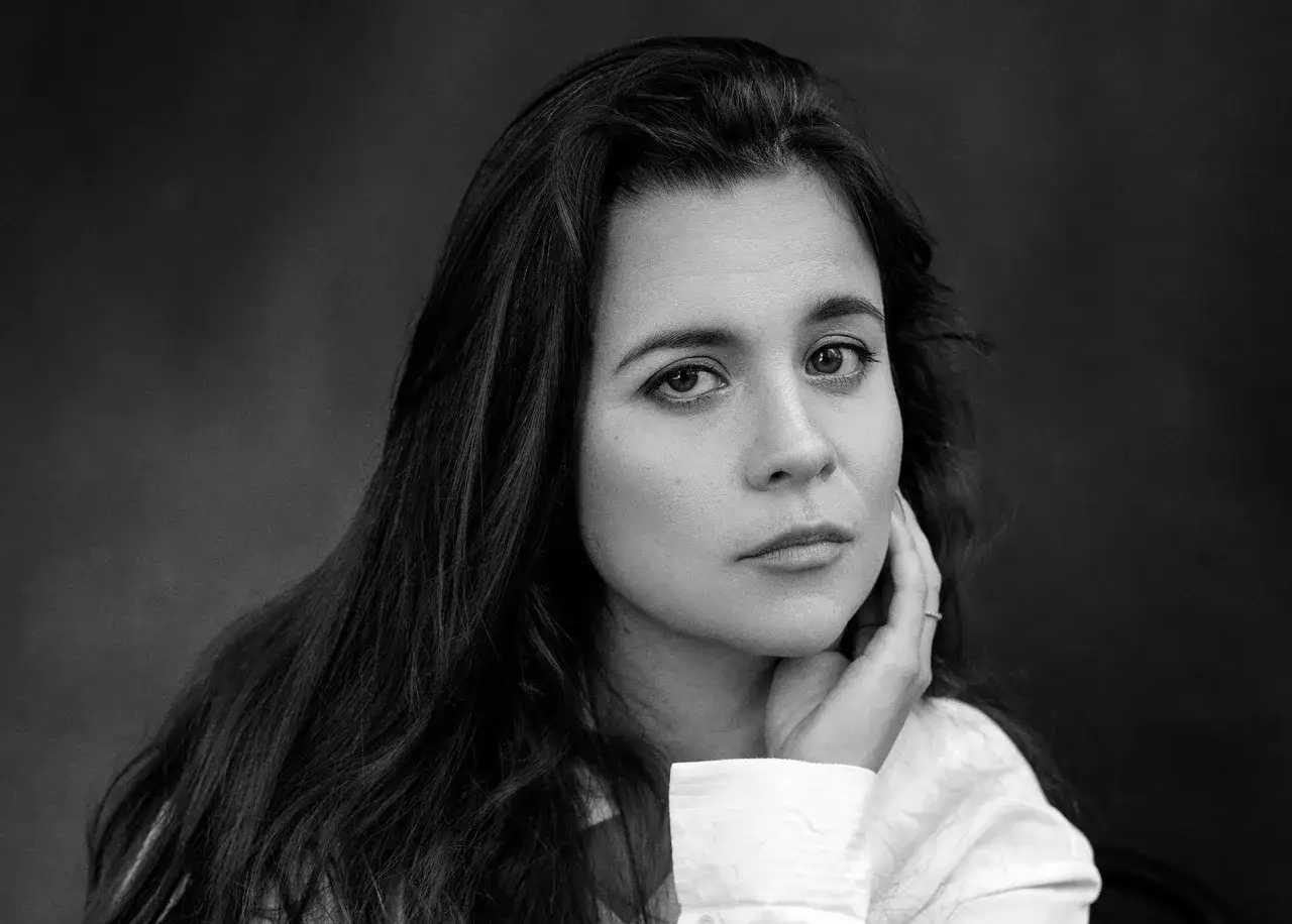 Svartvit bild på Caroline Ringskog Ferrada-Noli, med handen mot kinden.
