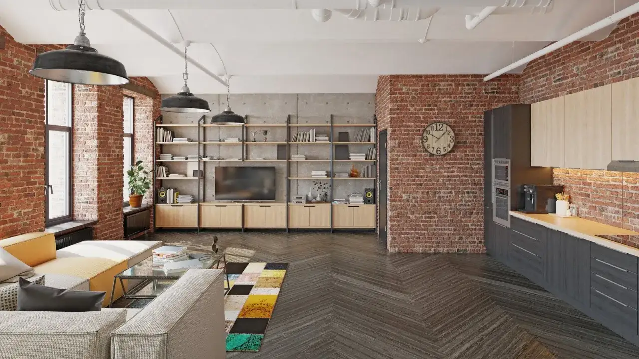 Nowoczesne atelier z ceglanymi ścianami, kanapą, kuchnią i regałami.