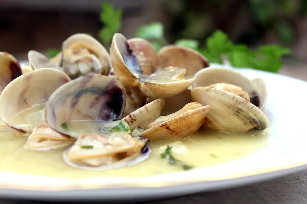 Deliciosas almejas en salsa verde, un plato que huele a mar y frescura.