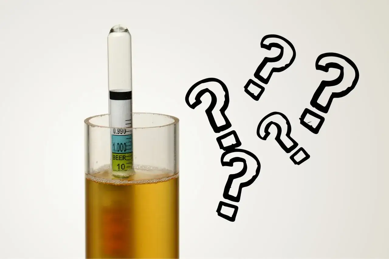 Densité IPA : un densimètre dans un verre de bière, entouré de points d'interrogation. Quel sera le résultat ?