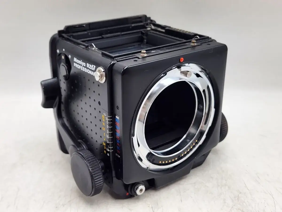 A Mamiya RZ67 Professional camera body, a classic medium format camera, sits on a white surface.