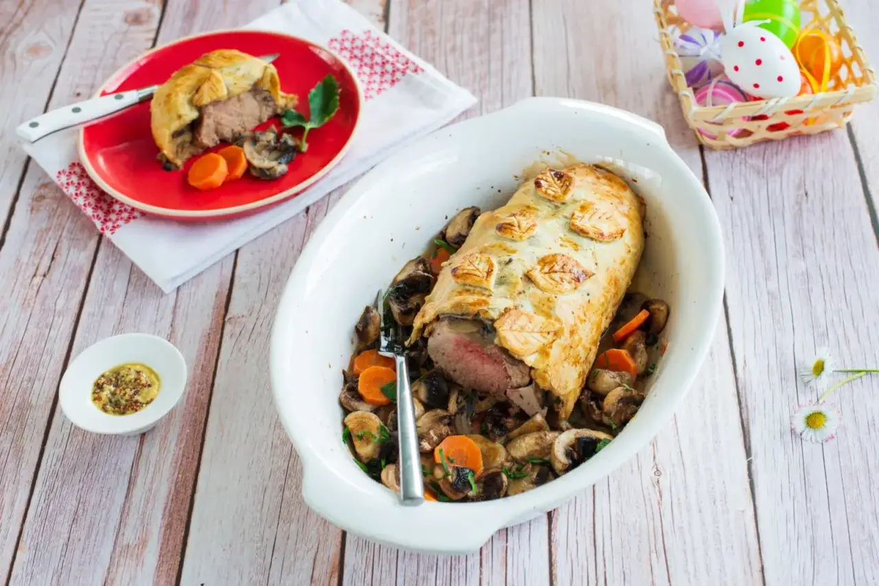 Filet mignon en croûte, prêt à être dégusté, servi avec des champignons et des carottes. Un délice facile à préparer avec le Cookeo.