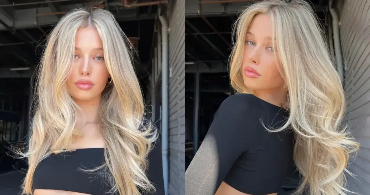 Blond włosy z subtelnym scandi hairline, falowane i lśniące, podkreślają delikatną urodę modelki.