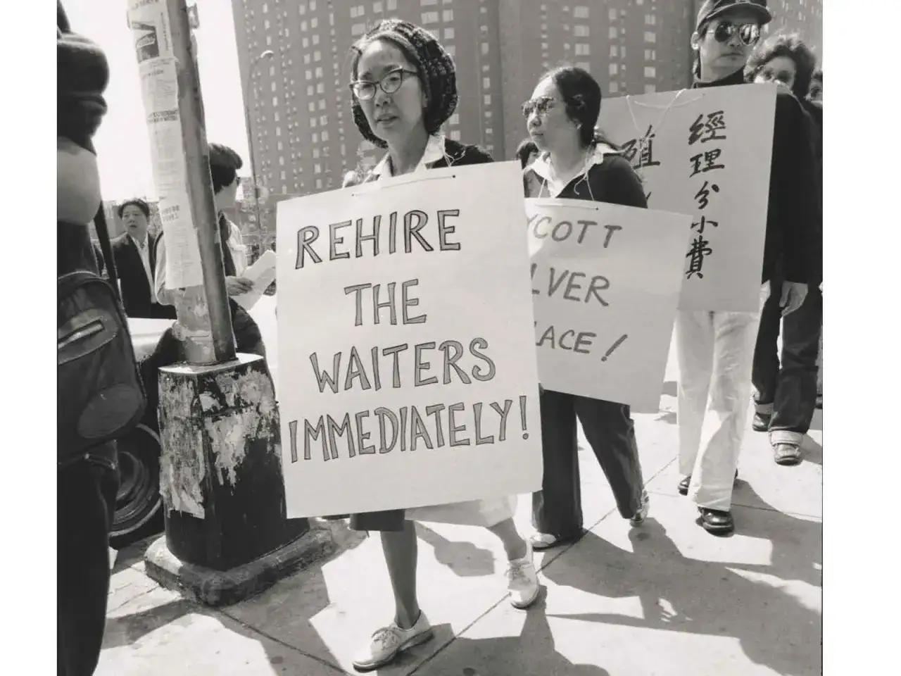A protestor holds a sign reading 