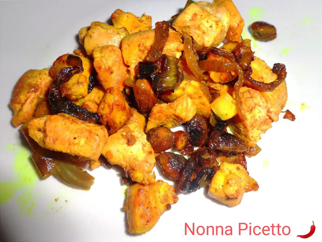 Spezzatino di pollo succulento con cipolle caramellate e uvetta, un piatto ricco di sapore.