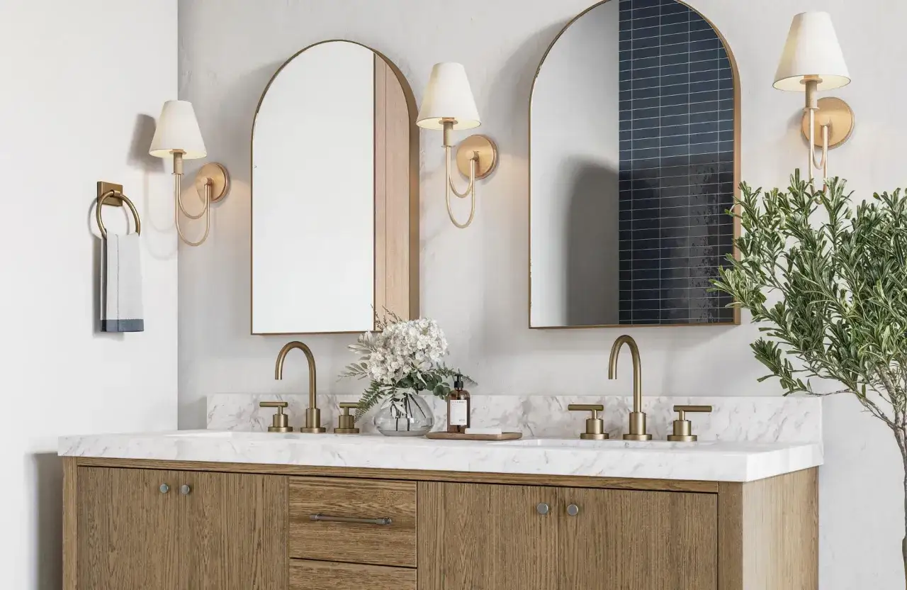 Elegant sconces flank arched mirrors, providing the best bathroom lighting for makeup. A double vanity with wood cabinetry and marble countertop.