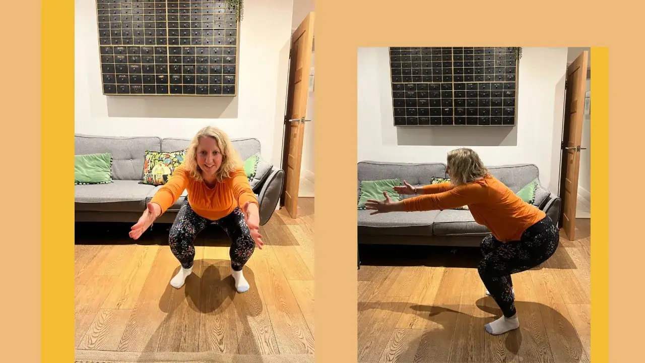 Donna fa uno squat a casa, con le braccia tese in avanti.