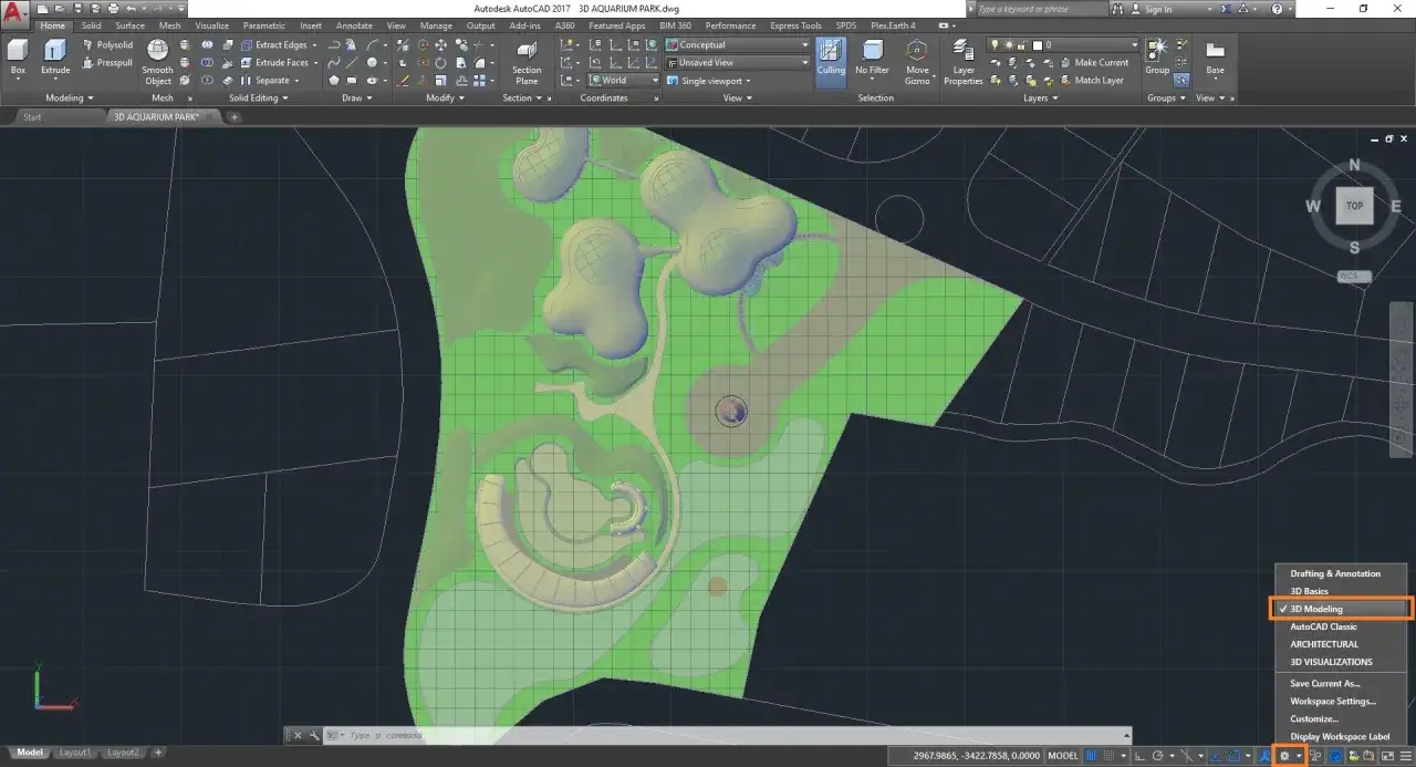 Projekt 3D akwarium na ekranie MacBook z uruchomionym AutoCAD. Widoczny interfejs programu i elementy projektu.