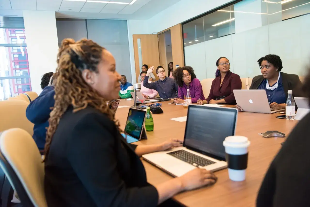 A diverse group of people in a meeting, embodying the principles of diversity, equity, and inclusion as they collaborate.