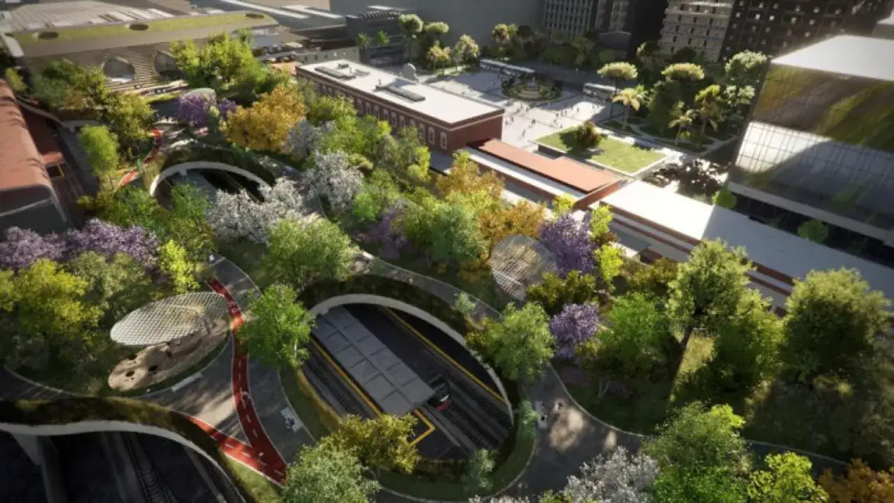 Un progetto di rigenerazione urbana trasforma un'area con tunnel e binari in un'oasi verde con percorsi pedonali e ciclabili.