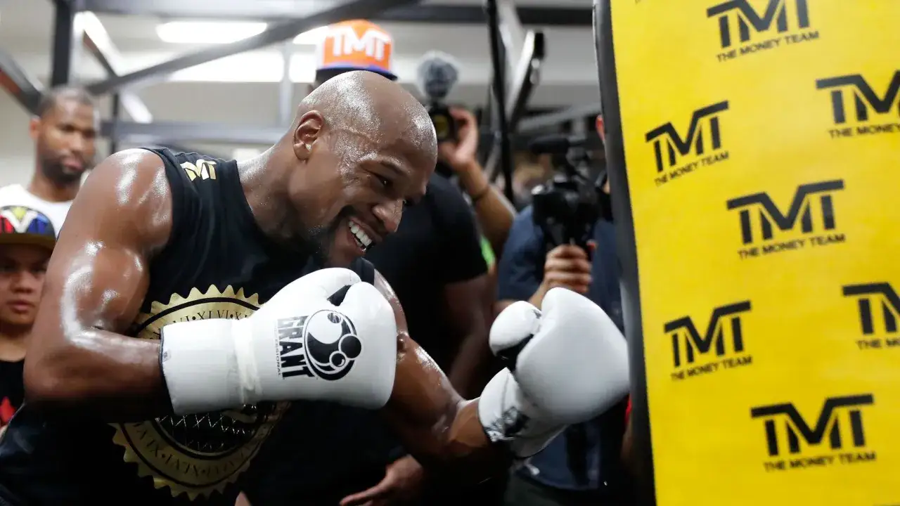 Floyd Mayweather Jr. trains with white Grant Professional gloves, his signature 