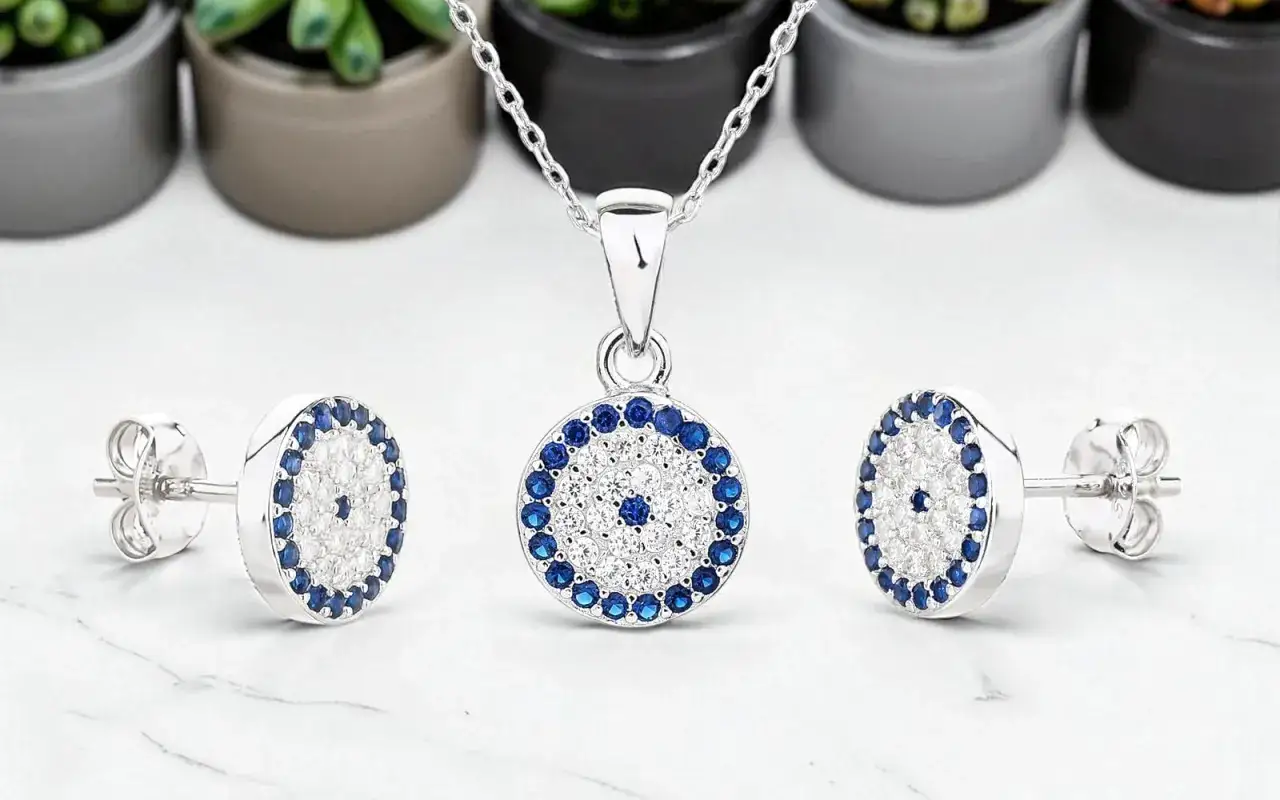 Conjunto de collar y pendientes de **plata 925** con diseño de ojo turco, adornado con circonitas blancas y azules.