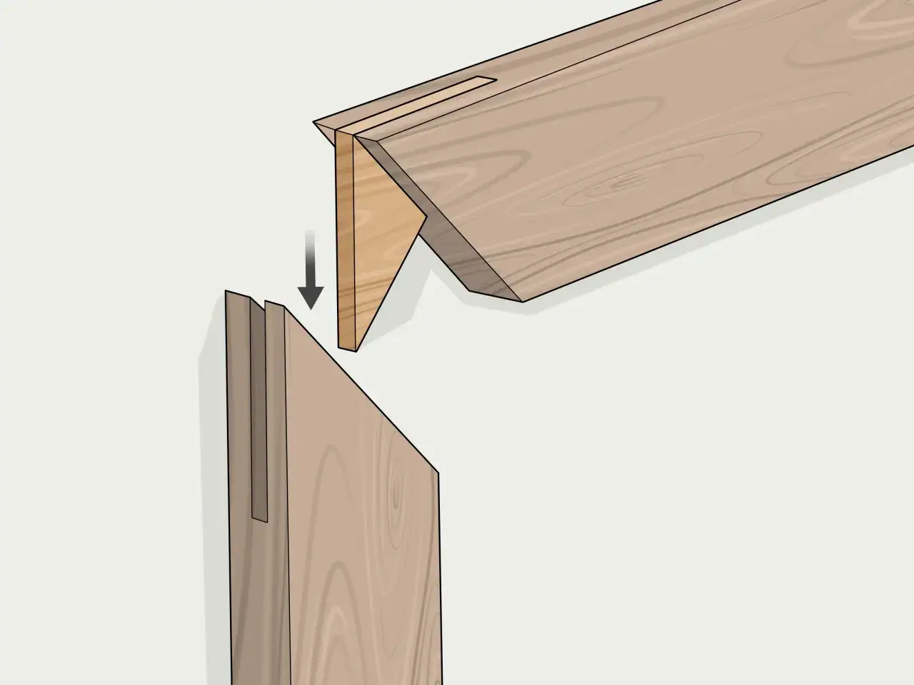 Ensamblaje de madera con un corte a inglete, mostrando cómo encajan dos piezas con ranuras y lengüetas para crear una unión fuerte y precisa.