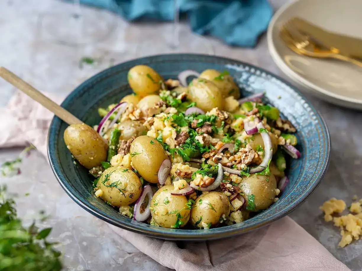 En h&auml;rlig potatissallad med sparris, r&ouml;dl&ouml;k och valn&ouml;tter, toppad med f&auml;rska &ouml;rter. Perfekt som tillbeh&ouml;r!