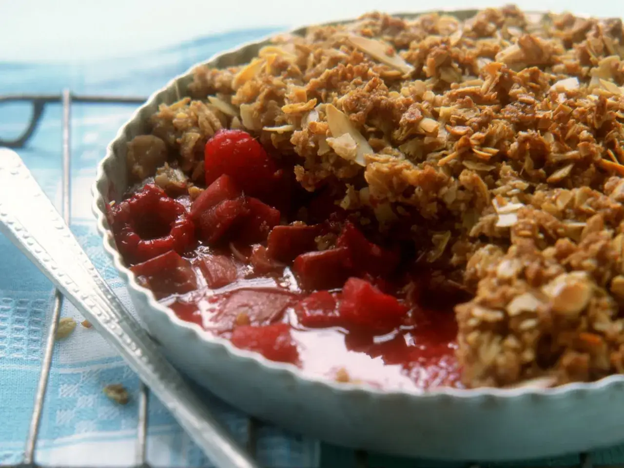 Himbeer Crumble mit knuspriger Haferflocken-Decke und saftigen roten Früchten. Ein Löffel wartet schon.