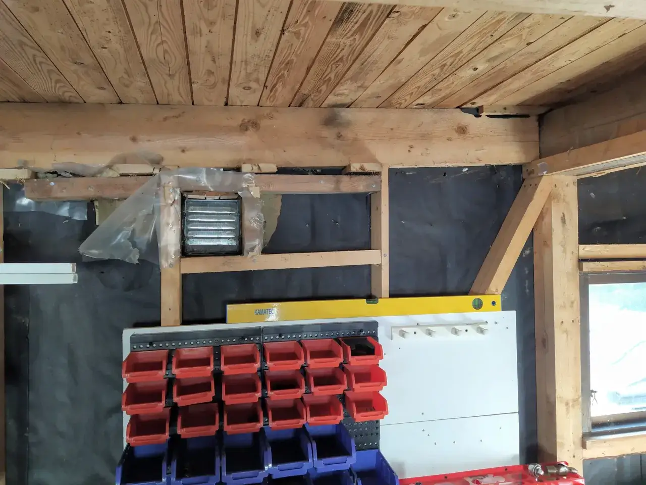 P&aring;g&aring;r arbete f&ouml;r att isolera garage. Syns tr&auml;bj&auml;lkar, isolering och f&ouml;rvaringssystem med fack.