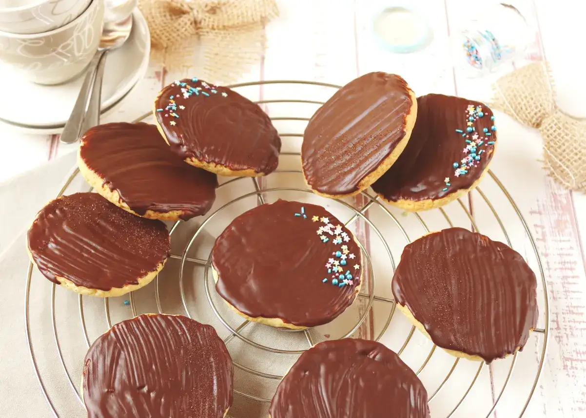 Omas Amerikaner Rezept: Leckere Schokokekse mit bunten Streuseln auf einem Kuchengitter.