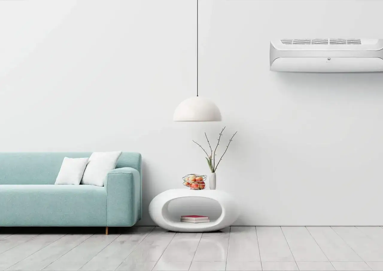 Nowoczesny salon z klimatyzatorem, sofą i stolikiem.