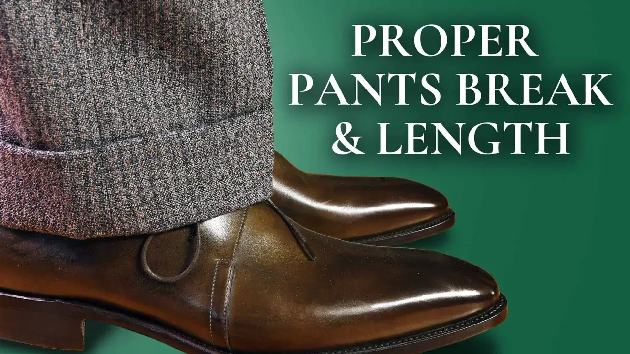 Close-up of textured grey pants with a cuff, resting on polished brown leather shoes. The image illustrates proper pants break & length, explaining the unhemmed pants meaning.