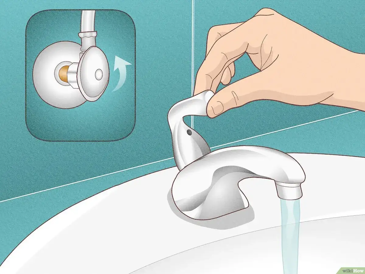 Chiudi l'acqua per cambiare rubinetto lavandino bagno. La mano gira la valvola di intercettazione.