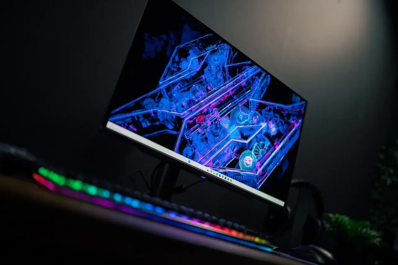 Ręka trzymająca monety przed monitorem