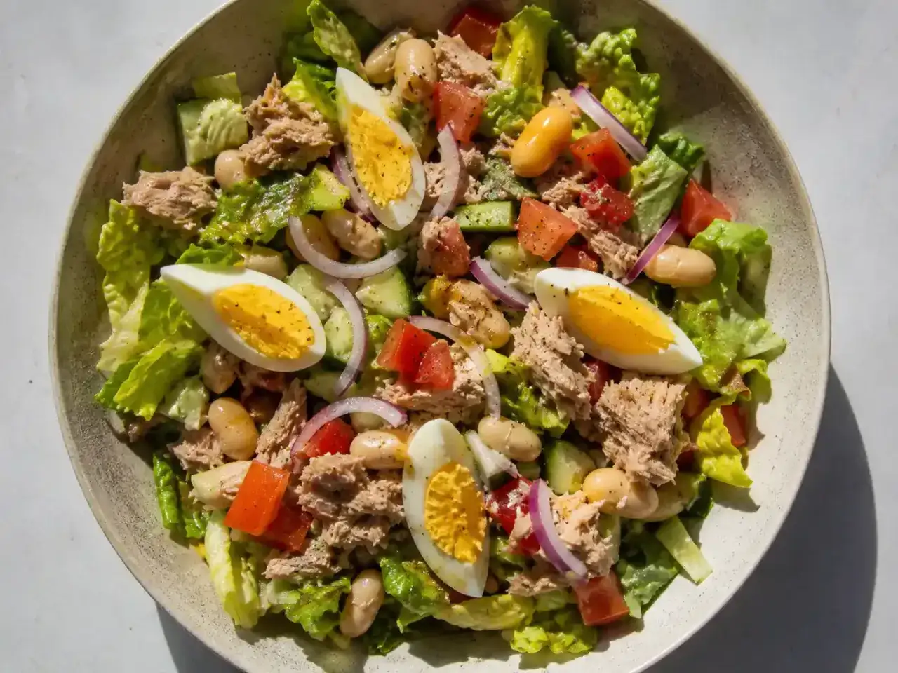 En fr&auml;sch tonfisksallad med &auml;gg, b&ouml;nor, tomat och gurka, perfekt som en l&auml;tt lunch.