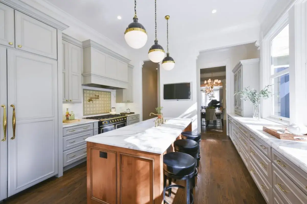 Black leather stools at a kitchen island, perfect for a counter height, not a barstool height.
