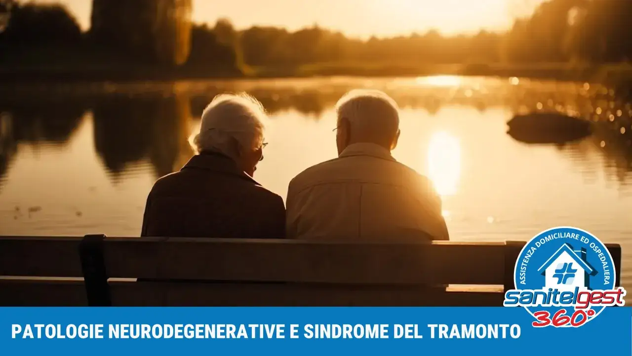 Coppia anziana seduta su una panchina al tramonto, riflettendo sulla sindrome del tramonto e le patologie neurodegenerative.