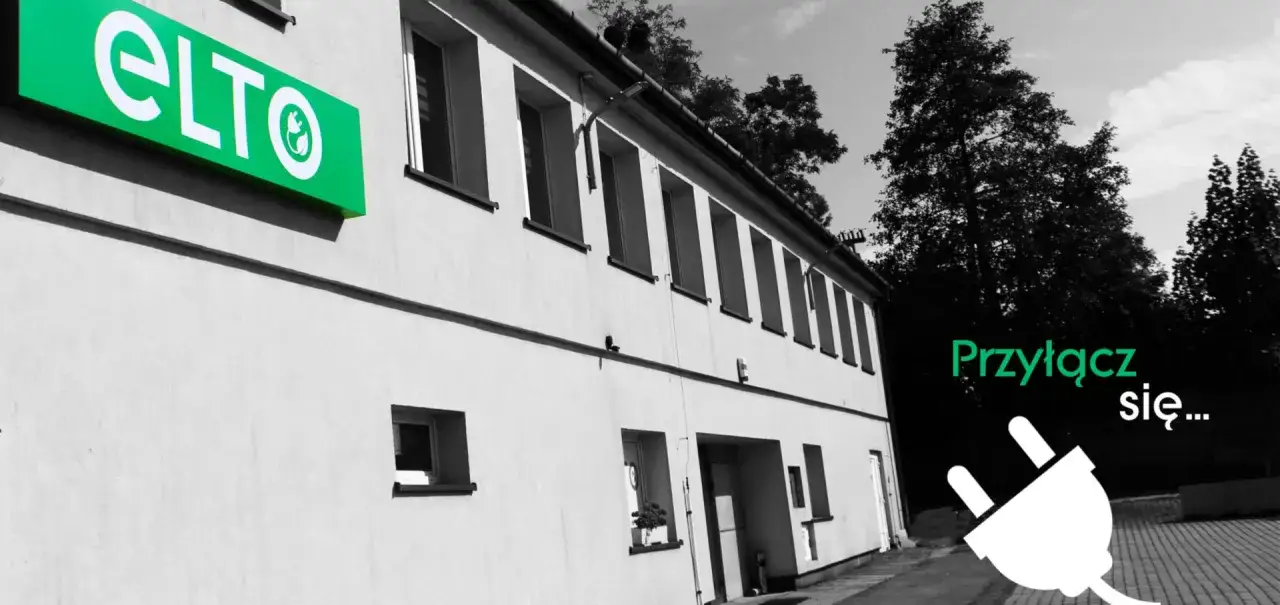 Hurtownia elektryczna ELTO zaprasza do przyłączenia się. Zielony neon ELTO na budynku, obok wtyczka elektryczna.