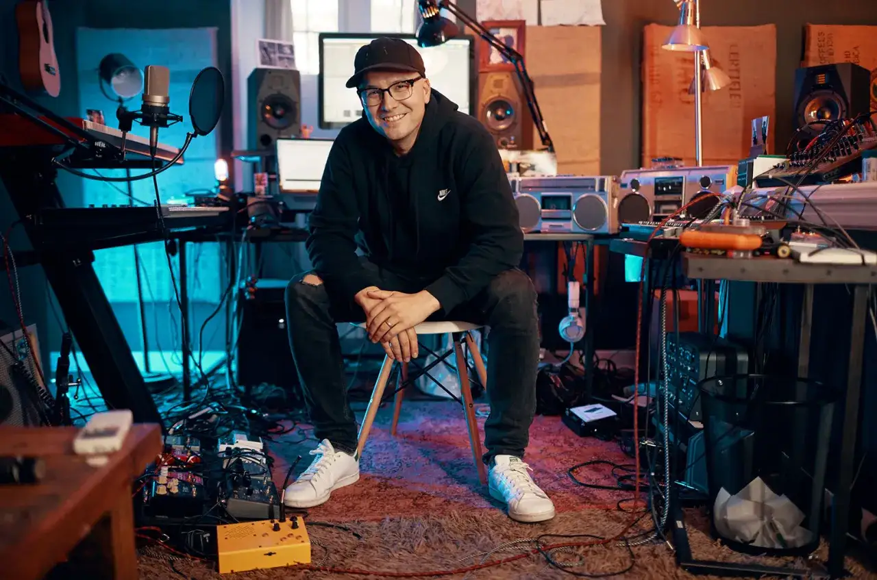 Luke Laird in his studio, surrounded by music gear, ready to create more amazing luke laird songs.