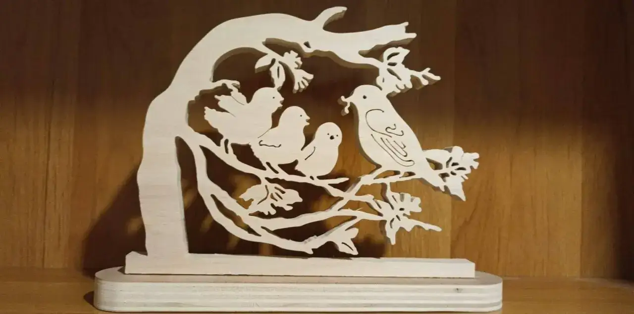 Modèle pour scie à chantourner : un arbre stylisé en bois avec quatre oiseaux perchés sur ses branches.