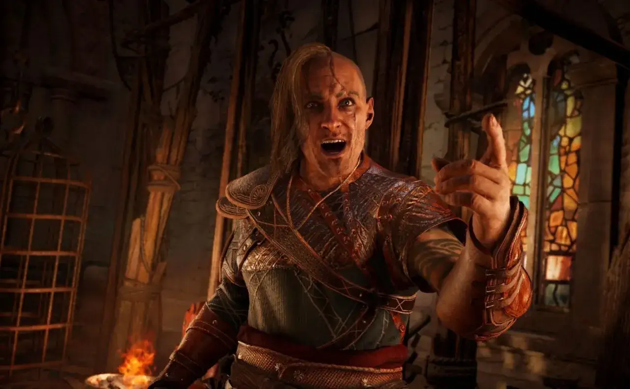 Wojownik z Assassin's Creed Valhalla, z otwartymi ustami i uniesionym palcem, w zbroi. Sprawdź wymagania sprzętowe gry!