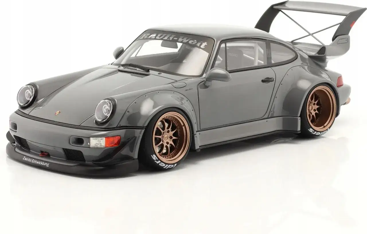 Szary Porsche RWB z szerokimi błotnikami i złotymi felgami, gotowy do driftu.