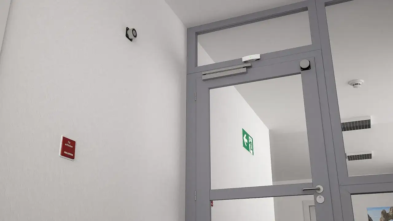 Türschließer-System nach DIN 14677 an einer Glastür mit Notausgangsschild.