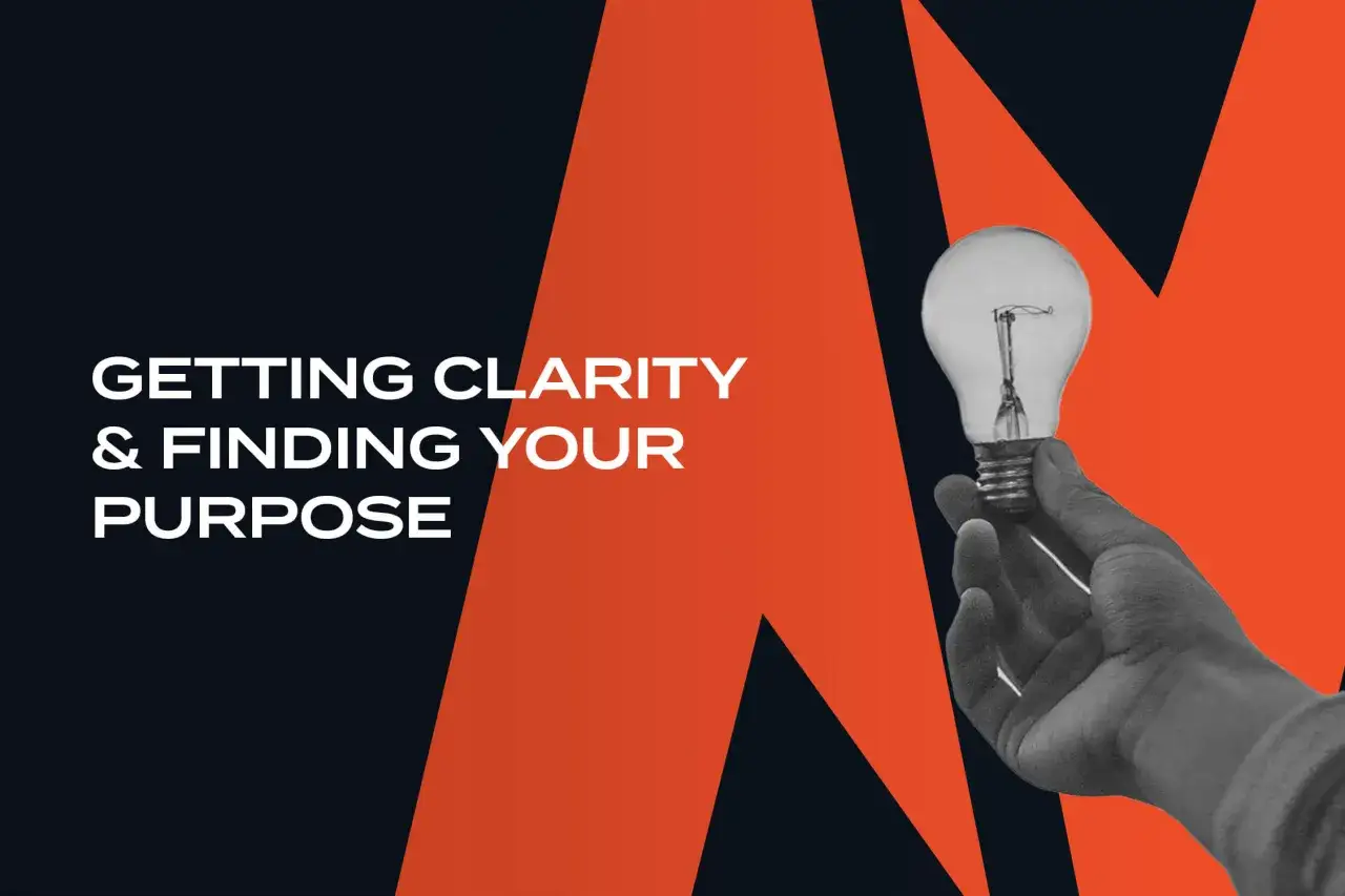 A hand holds a lightbulb, symbolizing how to get unstuck by finding clarity and purpose.
