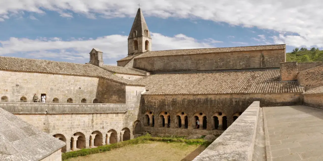 Vue sur les clo&icirc;tres de l'abbaye du Thoronet, avec son clocher &eacute;lanc&eacute; et ses arcades de pierre.