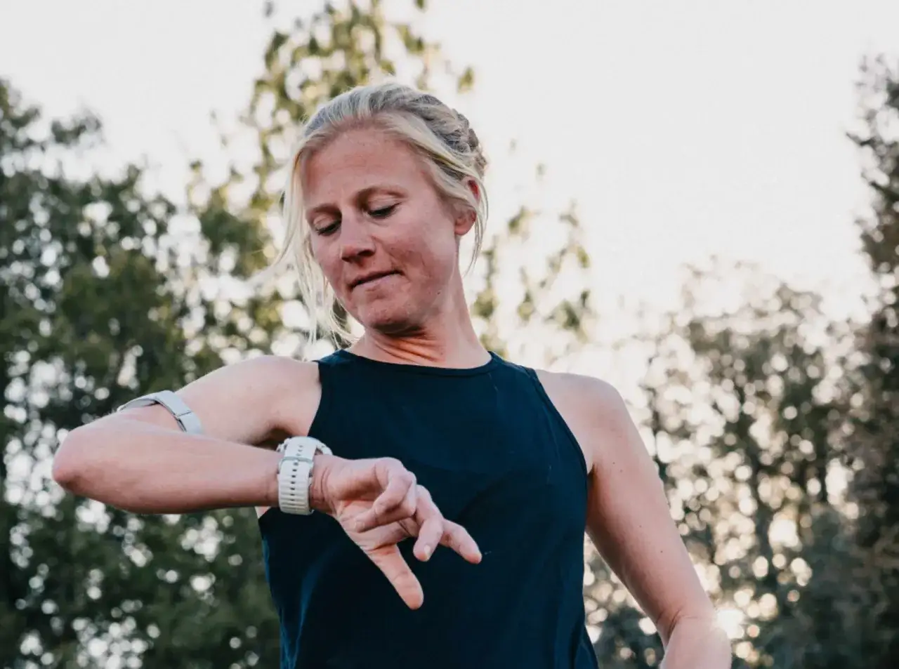 Läuferin prüft ihre Uhr, bereit für den ultra marathon.