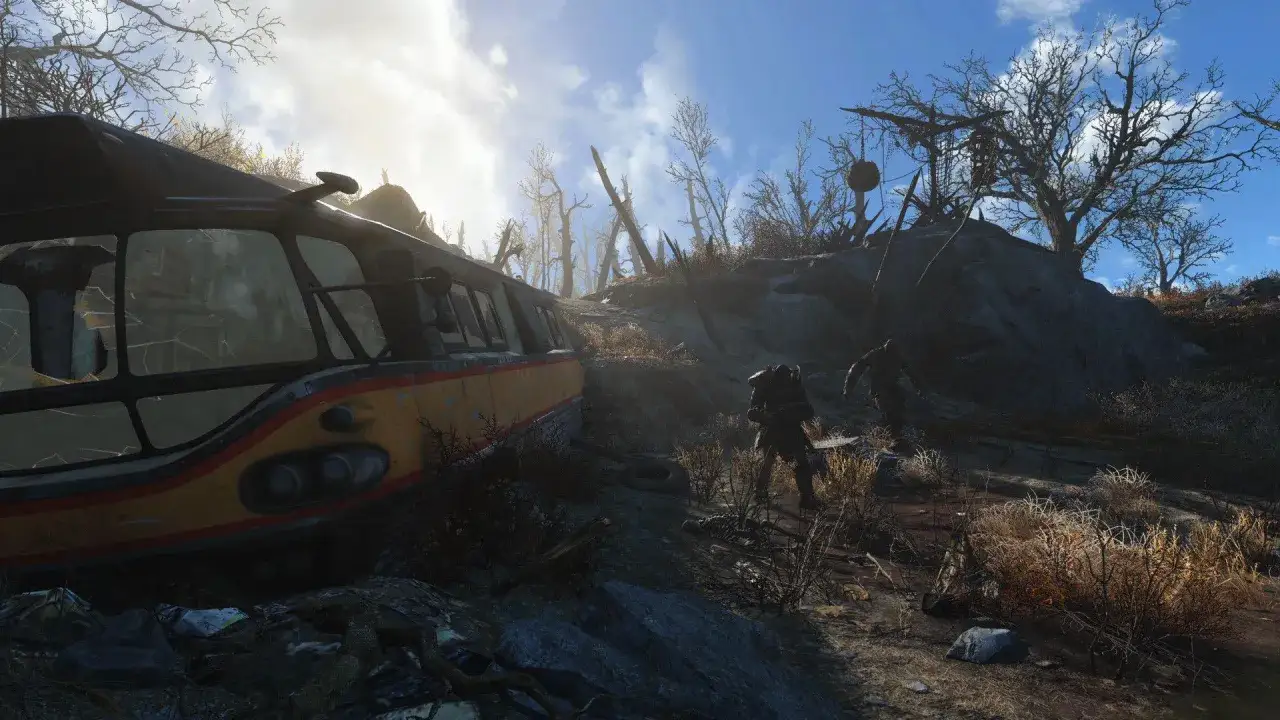 Verlassener Buswrack in postapokalyptischer Landschaft. Ein Spielercharakter in R&uuml;stung n&auml;hert sich. Fallout 4 Test.